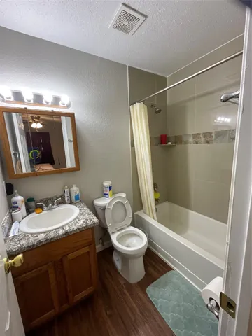 a bathroom with a sink toilet tub and shower
