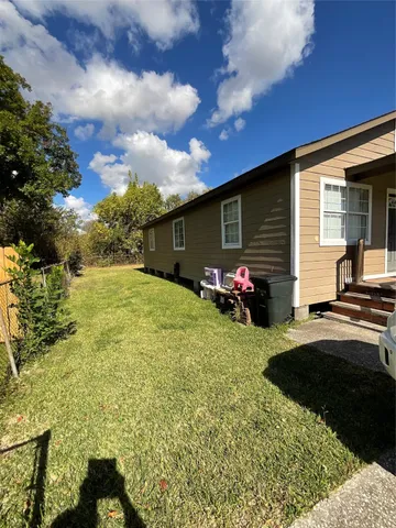 a view of a backyard with sitting area