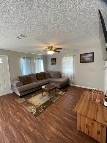 a living room with furniture and a rug