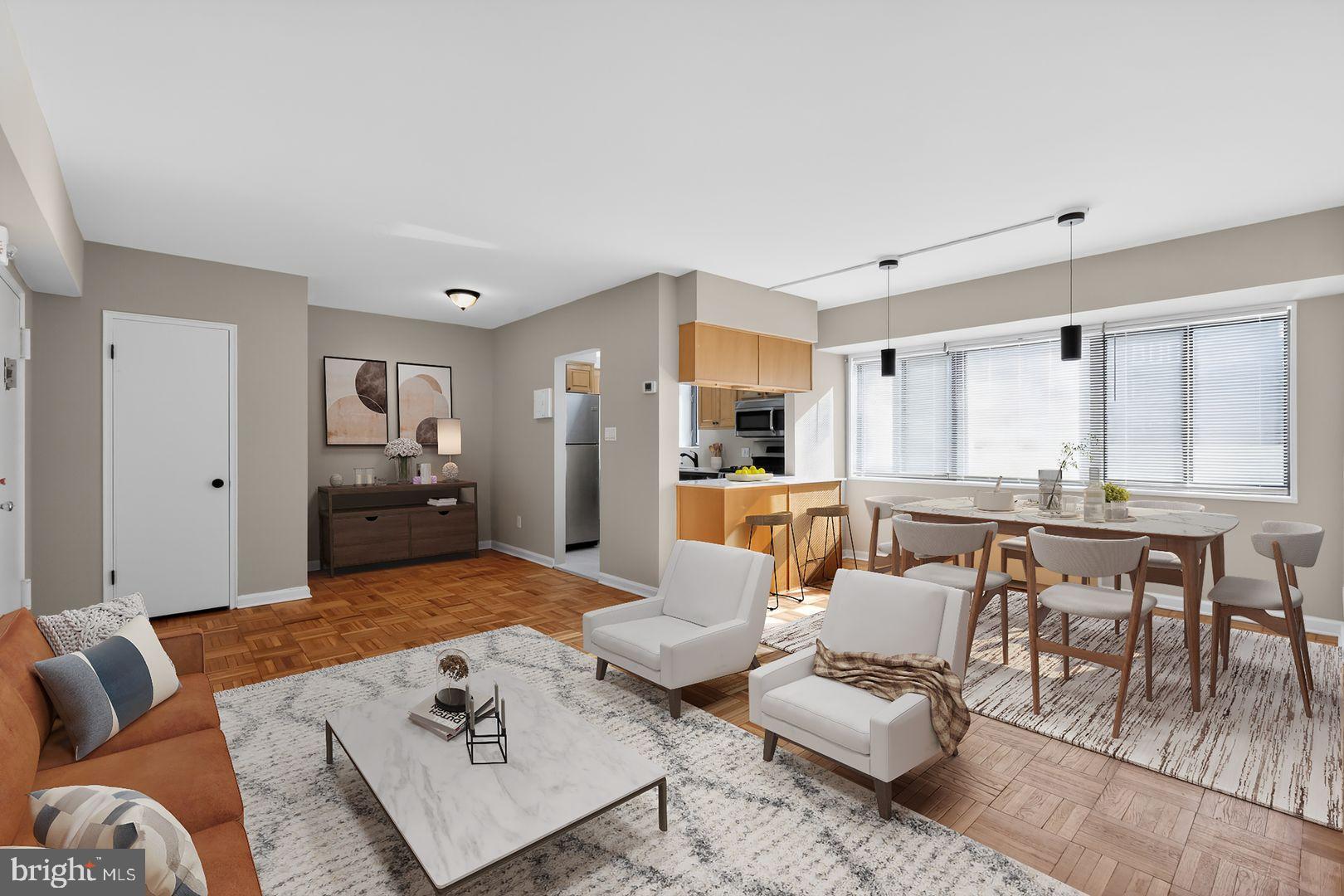 a living room with furniture wooden floor and a large window
