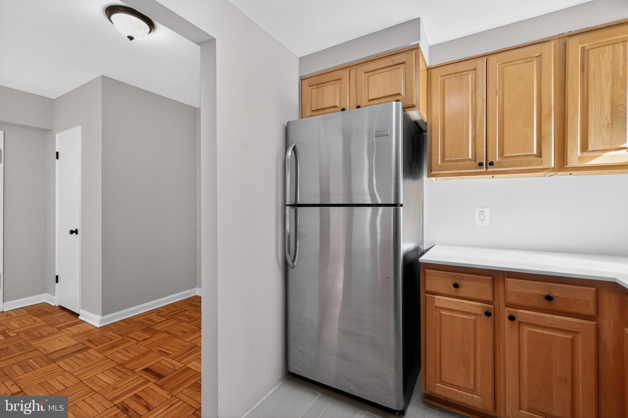 3701 Connecticut Avenue Northwest, Unit 233 Washington, DC 20008 - Photo 15 of 31 a view of a kitchen with wooden floor and a refrigerator