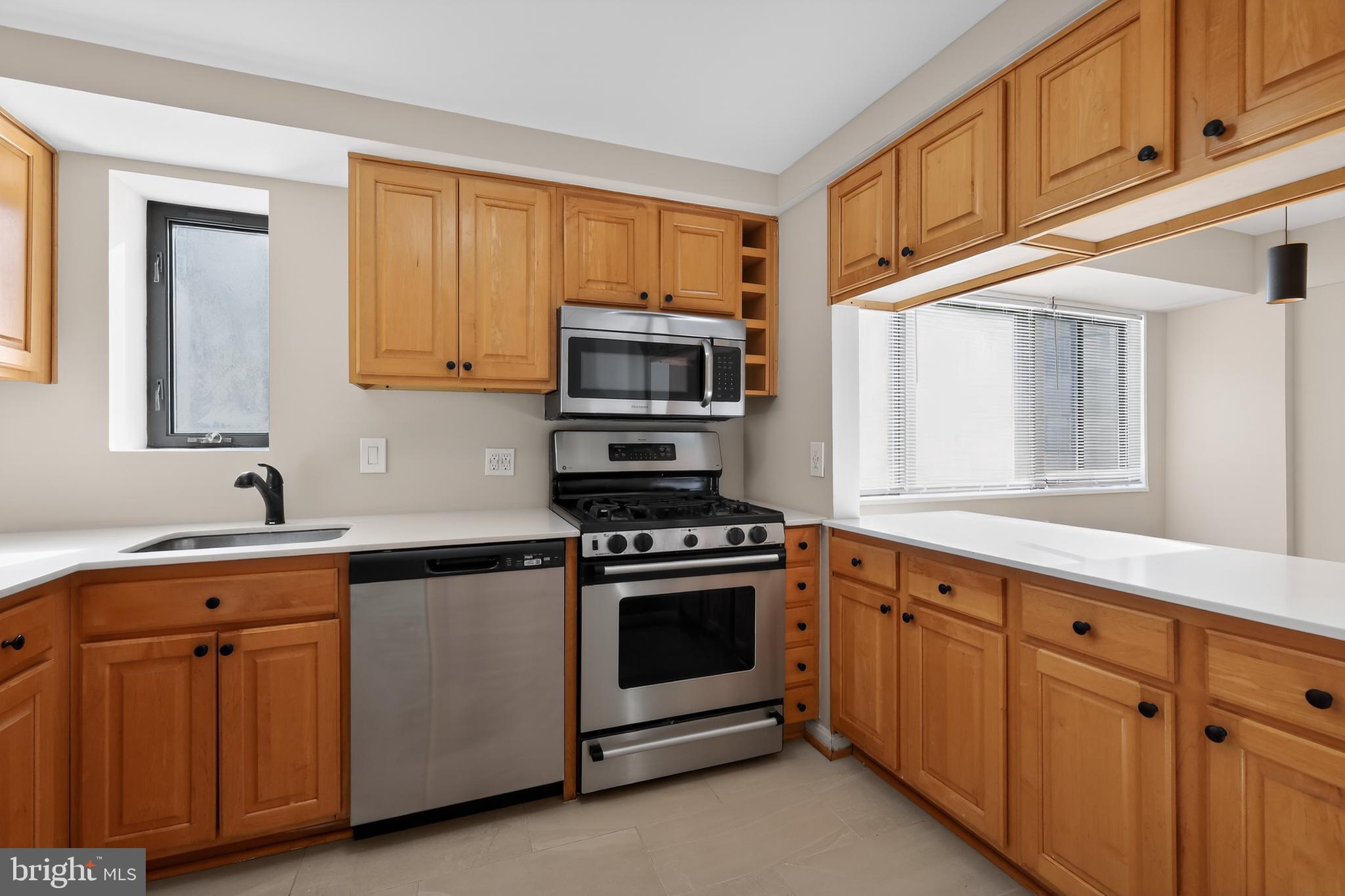 3701 Connecticut Avenue Northwest, Unit 233 Washington, DC 20008 - Photo 16 of 31 a kitchen with cabinets stainless steel appliances and a sink