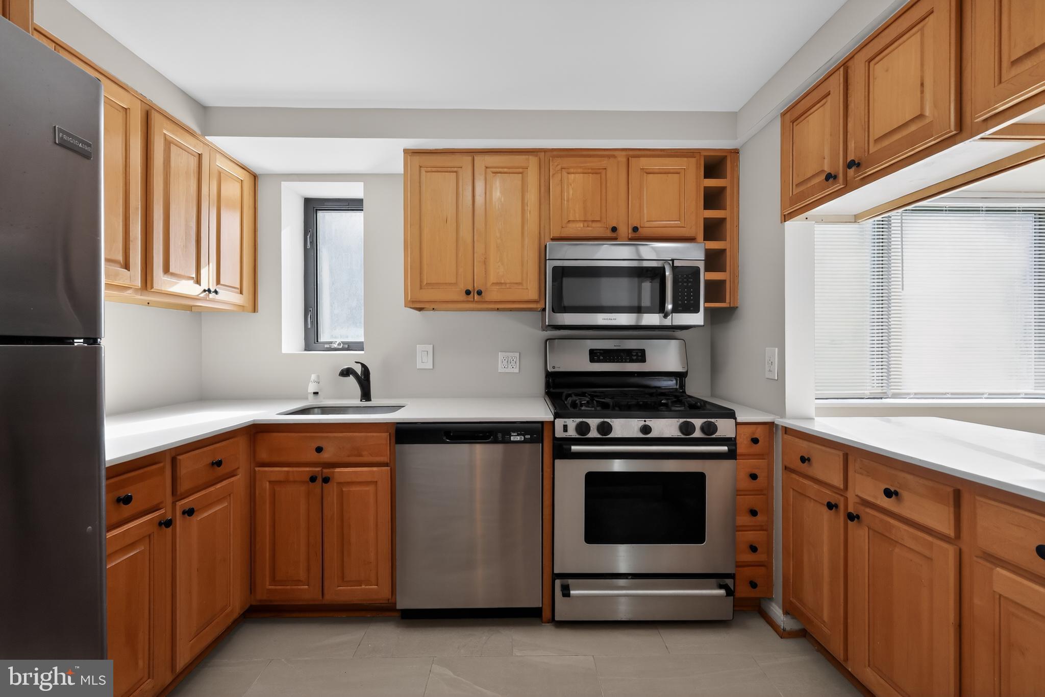 3701 Connecticut Avenue Northwest, Unit 233 Washington, DC 20008 - Photo 18 of 31 a kitchen with cabinets appliances a sink and a window