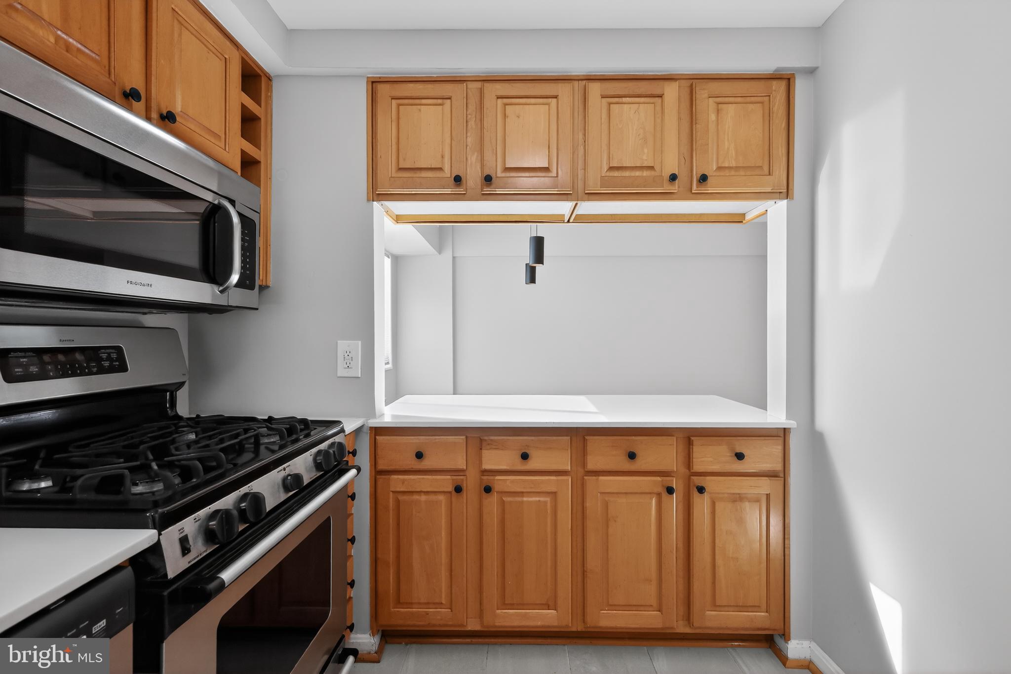 3701 Connecticut Avenue Northwest, Unit 233 Washington, DC 20008 - Photo 20 of 31 a kitchen with stainless steel appliances a stove and a microwave