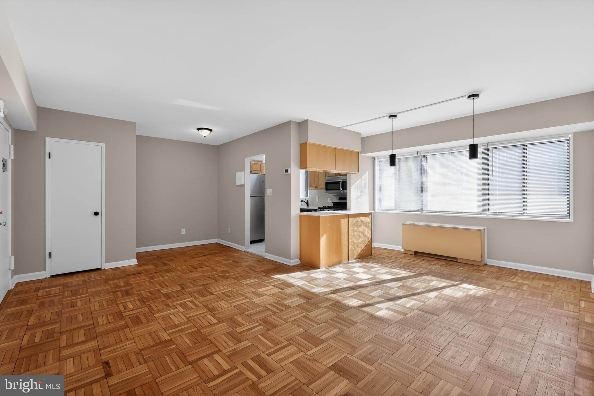 3701 Connecticut Avenue Northwest, Unit 233 Washington, DC 20008 - Photo 2 of 31 a view of kitchen with refrigerator cabinets and wooden floor
