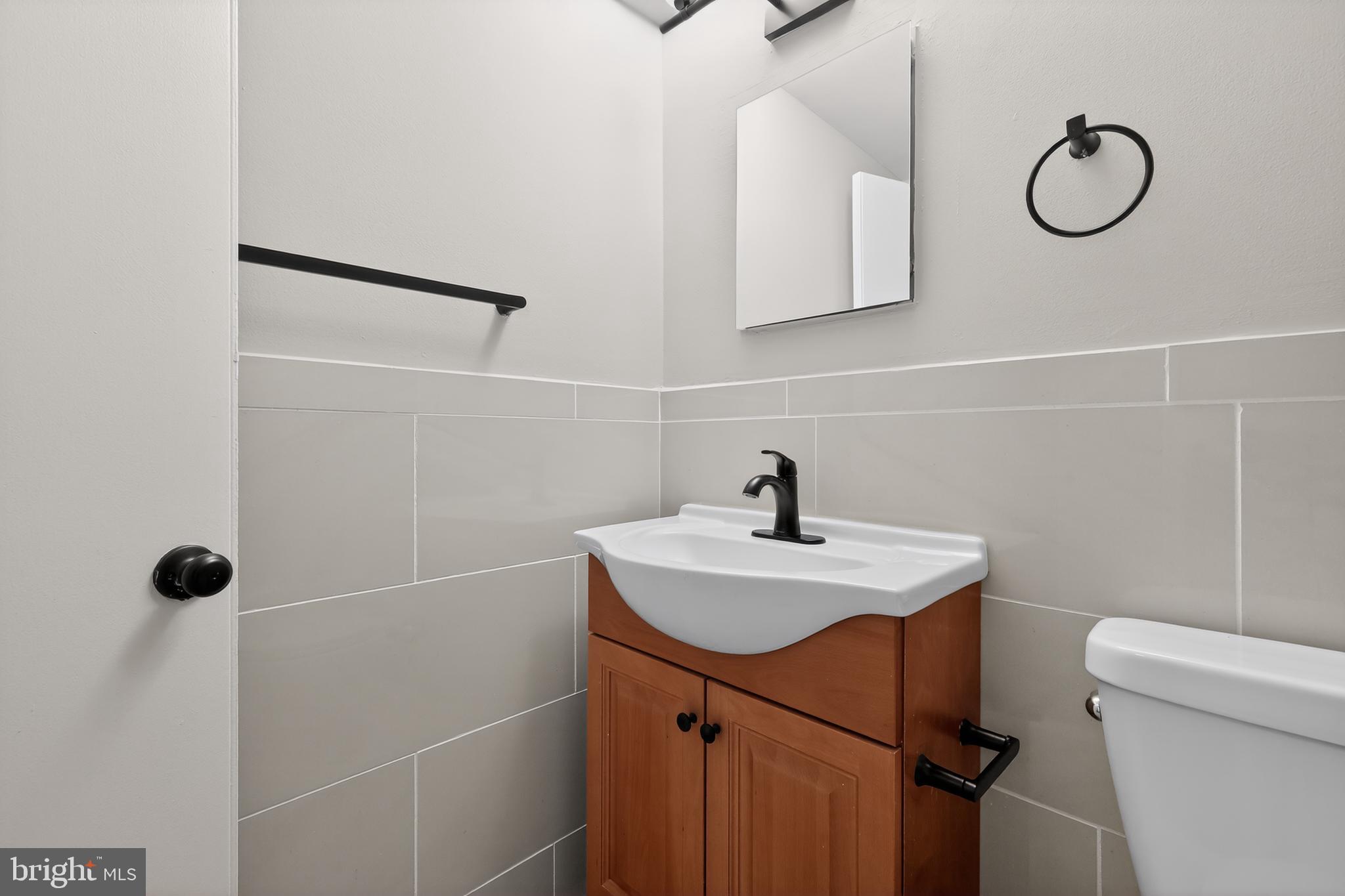3701 Connecticut Avenue Northwest, Unit 233 Washington, DC 20008 - Photo 28 of 31 a bathroom with a sink a toilet a mirror and vanity