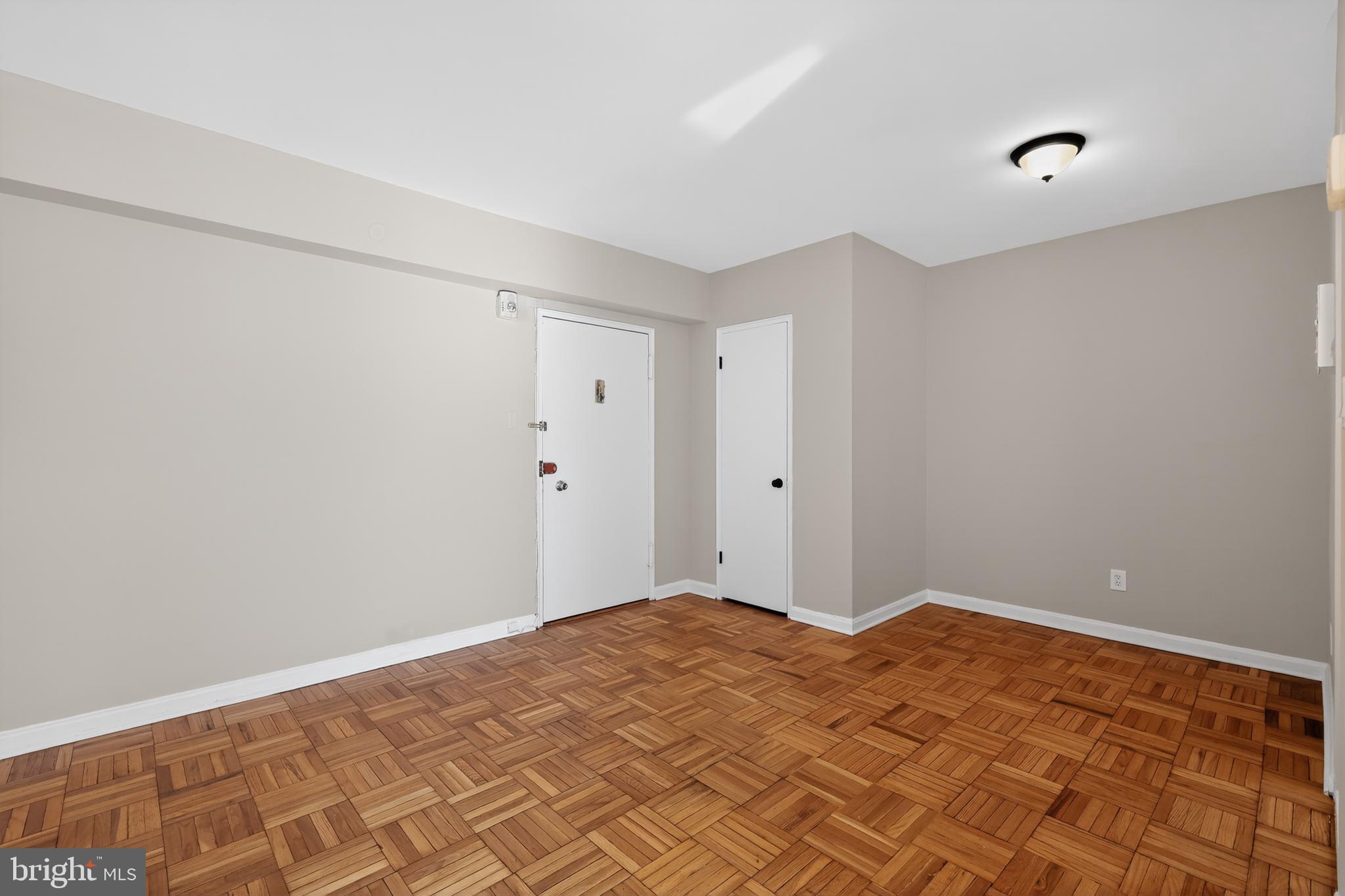 3701 Connecticut Avenue Northwest, Unit 233 Washington, DC 20008 - Photo 10 of 31 a bedroom with a bed and a window