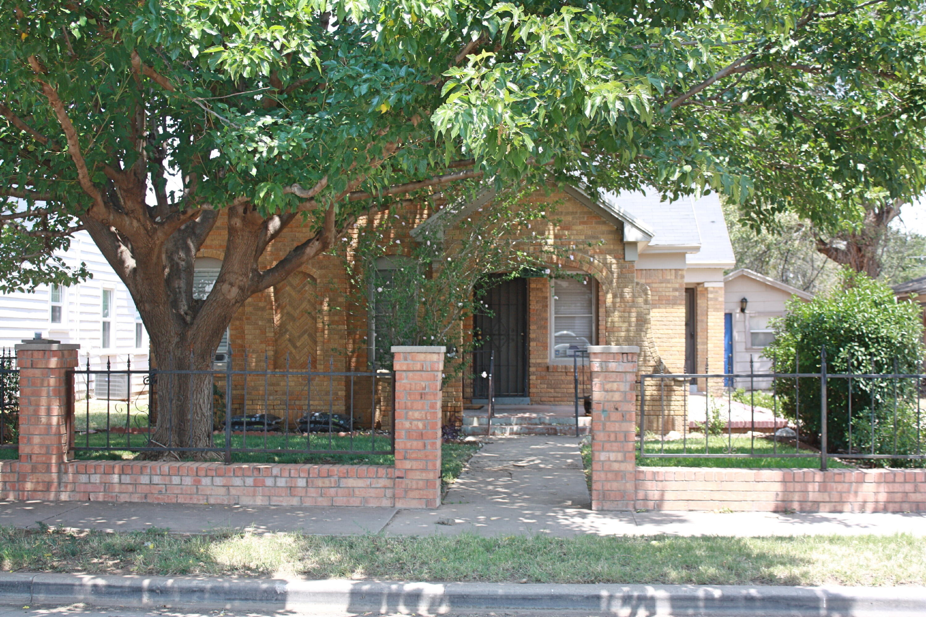 2118 27th Street, Unit FRONT Lubbock, TX 79411 - Photo 1 of 7 a front view of a house with a garden