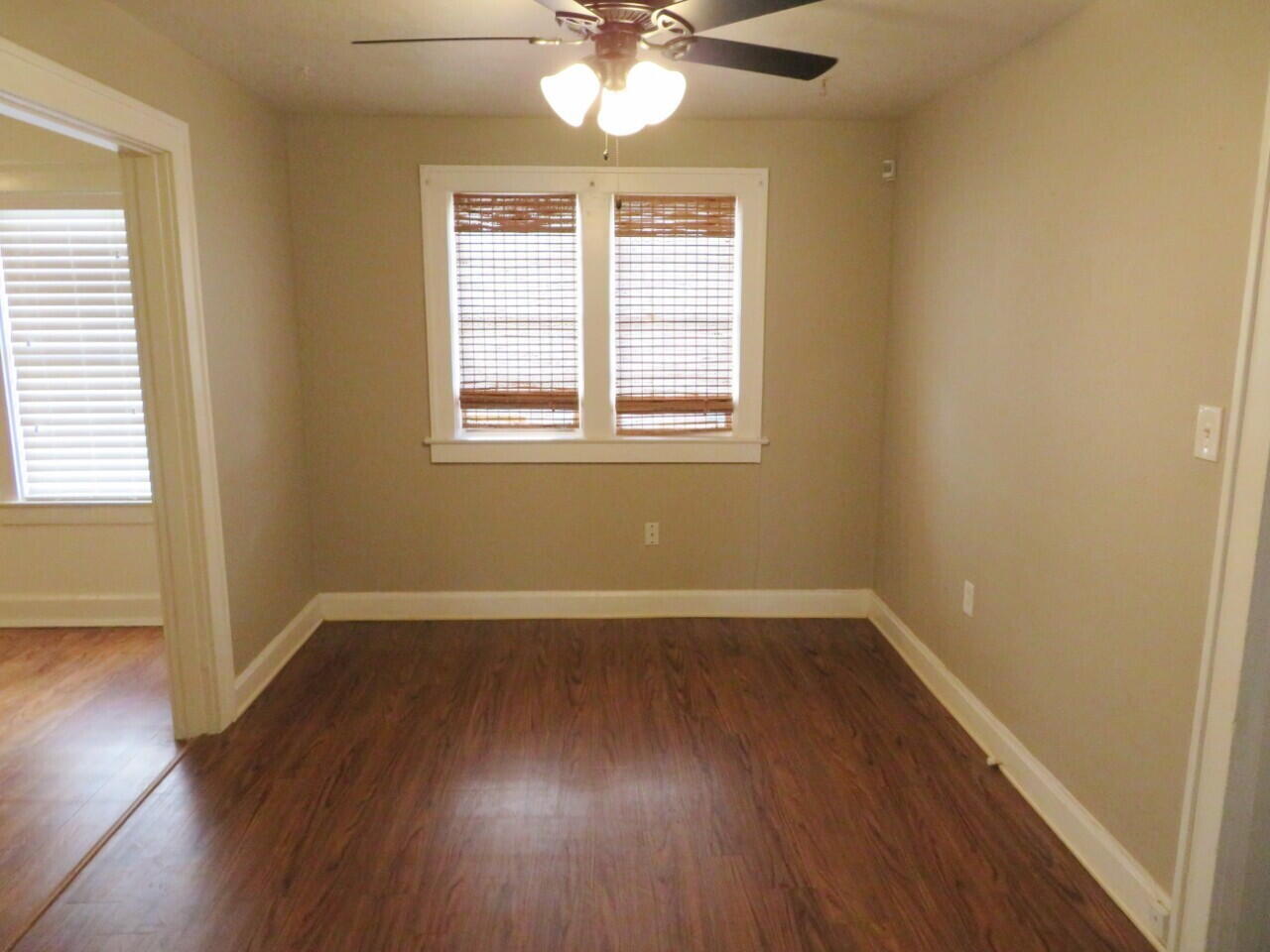 2118 27th Street, Unit FRONT Lubbock, TX 79411 - Photo 4 of 7 a view of an empty room with wooden floor and a window