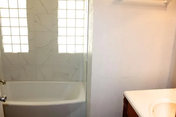 a bath tub sitting next to a window