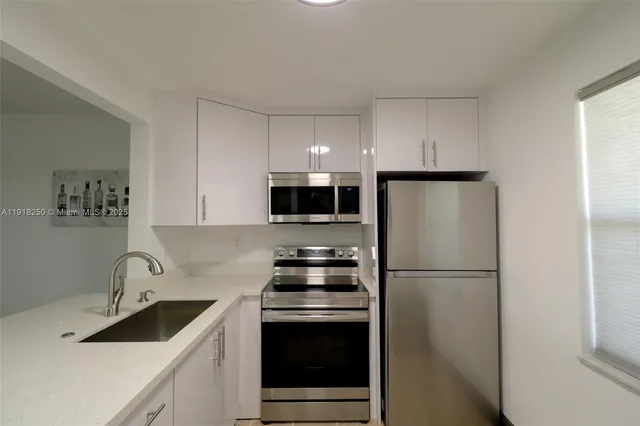 a kitchen with stainless steel appliances a refrigerator stove and sink