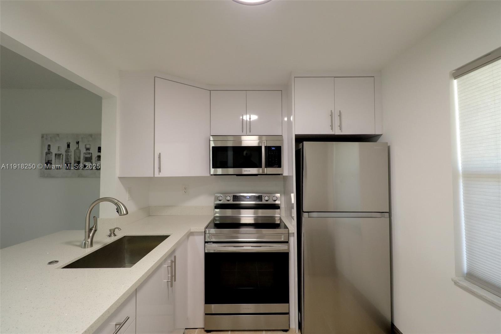 a kitchen with stainless steel appliances a refrigerator stove and sink