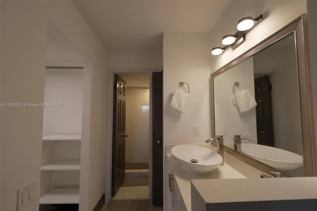 a bathroom with a sink and a mirror