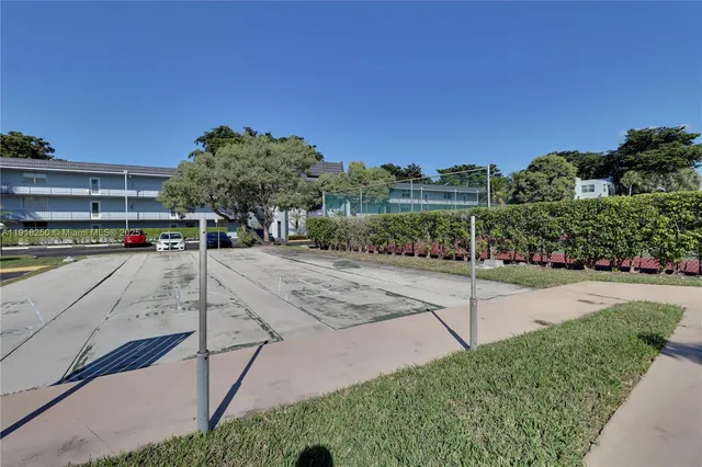 a view of a street with cars parked