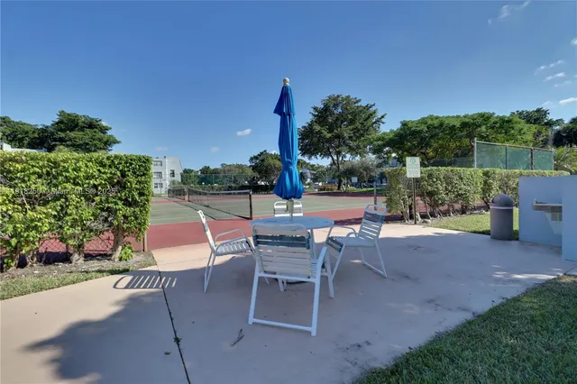 a view of a patio with table and chairs potted plants with wooden fence