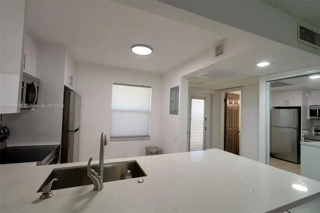 a large bedroom with a bed and a flat screen tv