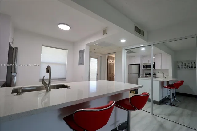 a room with stainless steel appliances furniture and kitchen view