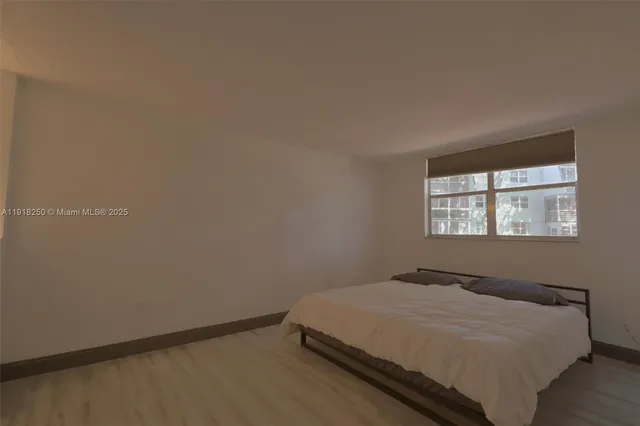 a bed sitting in a bedroom next to a window