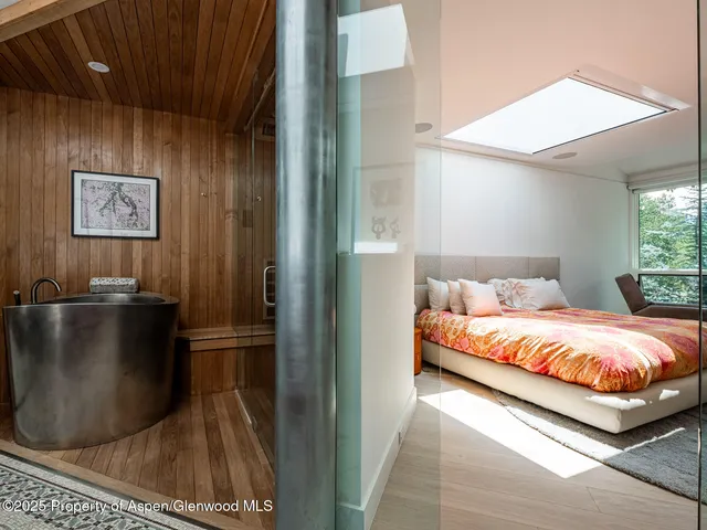 a bathroom with a sink vanity granite tub and a mirror