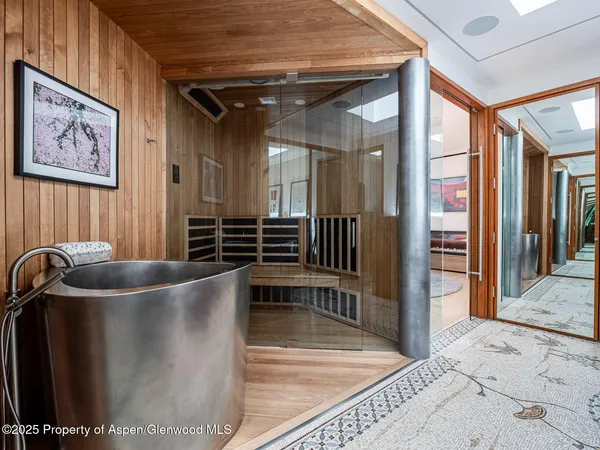 a living room with furniture a rug and a projector