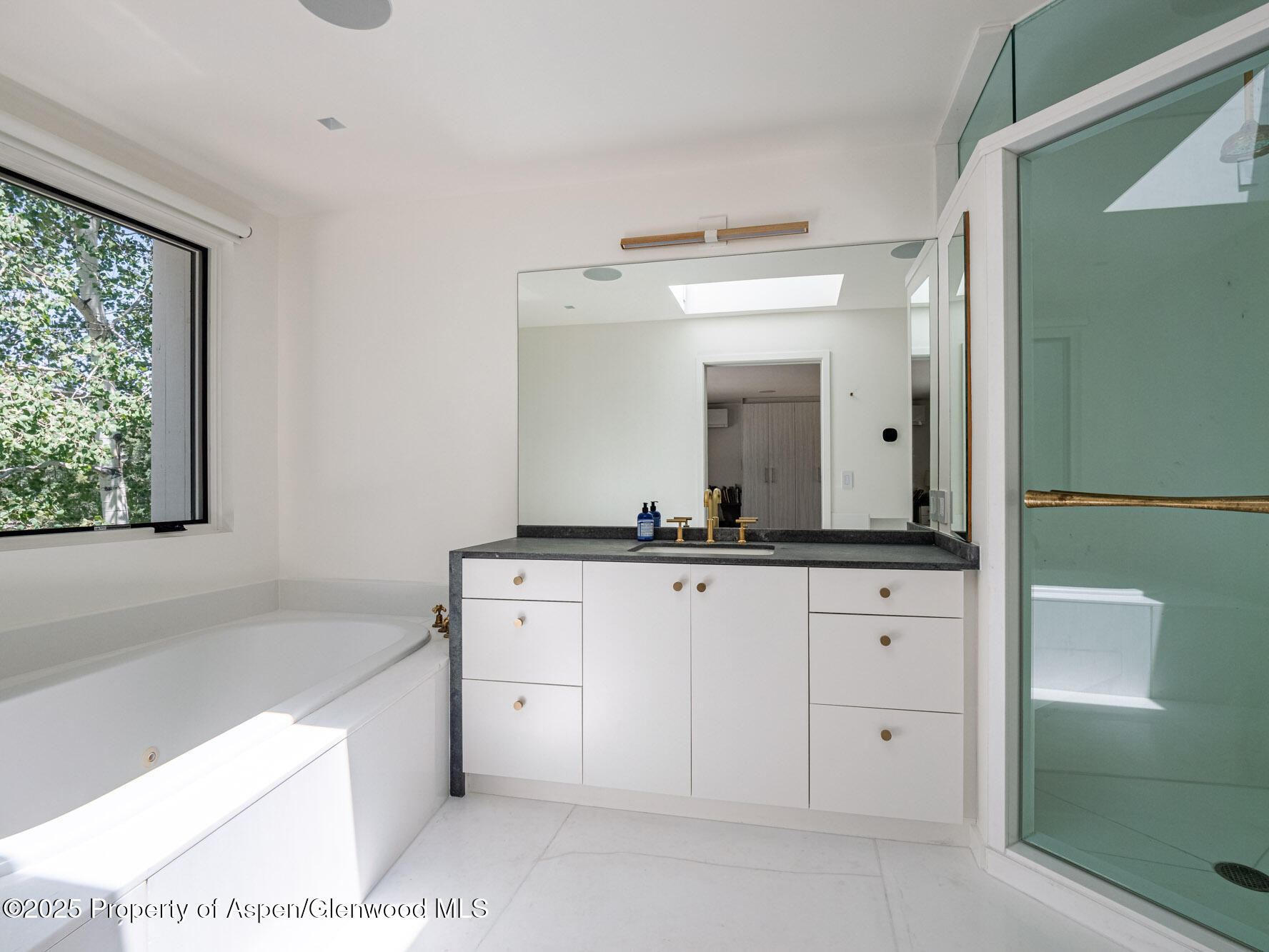 1440 Crystal Lake Road Aspen, CO 81611 - Photo 23 of 44 a bathroom with a sink vanity granite tub and a mirror