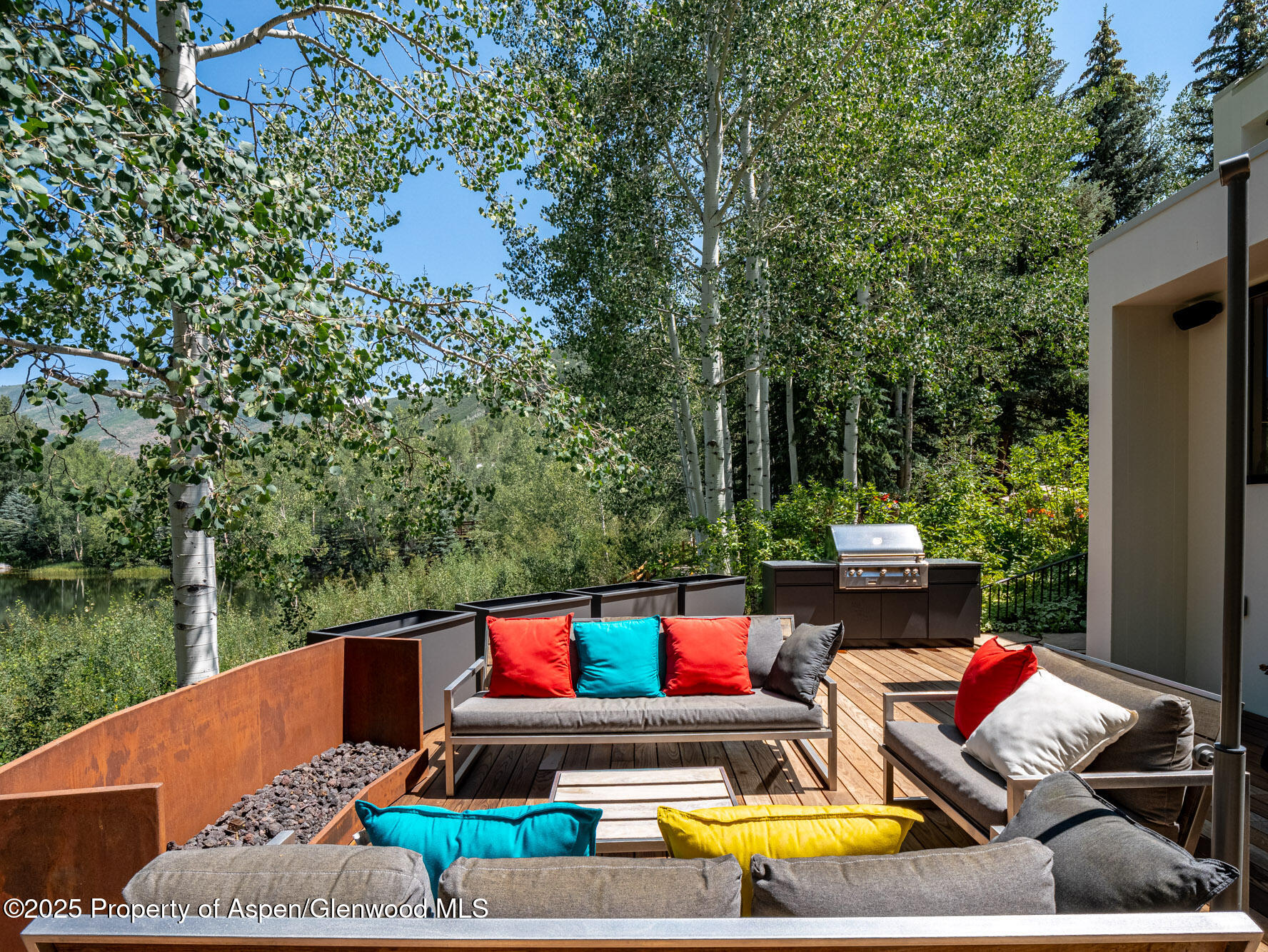 1440 Crystal Lake Road Aspen, CO 81611 - Photo 37 of 44 a view of a patio with couches table and chairs and potted plants