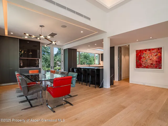 a living room with furniture a flat screen tv and a large window