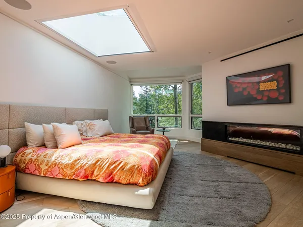 a bedroom with a bed and painting on the wall