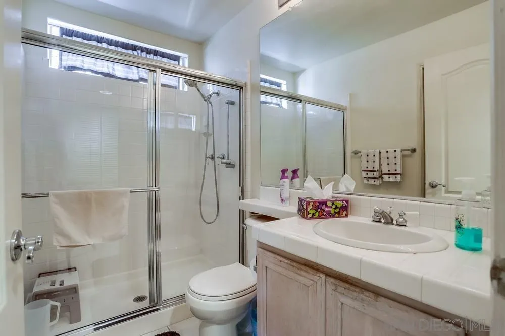 3243 San Tomas Drive Oceanside, CA 92056 - Photo 15 of 45 a bathroom with a granite countertop sink toilet and shower