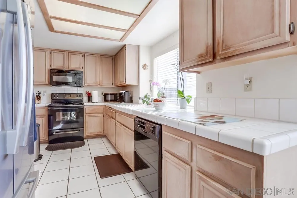 3243 San Tomas Drive Oceanside, CA 92056 - Photo 22 of 45 a kitchen with a sink window and cabinets