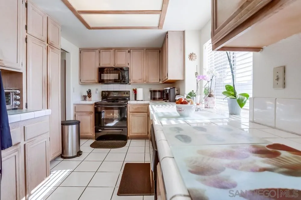 3243 San Tomas Drive Oceanside, CA 92056 - Photo 23 of 45 a kitchen with stainless steel appliances granite countertop a stove a sink and a refrigerator