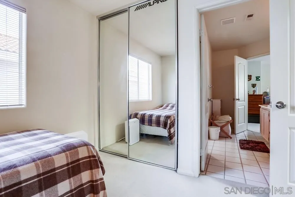 3243 San Tomas Drive Oceanside, CA 92056 - Photo 30 of 45 a bedroom with a bed and a window