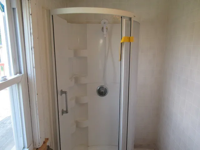 a bathroom with a shower and a glass door