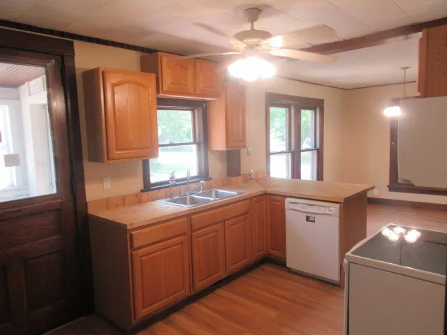 a kitchen with a sink and chandelier