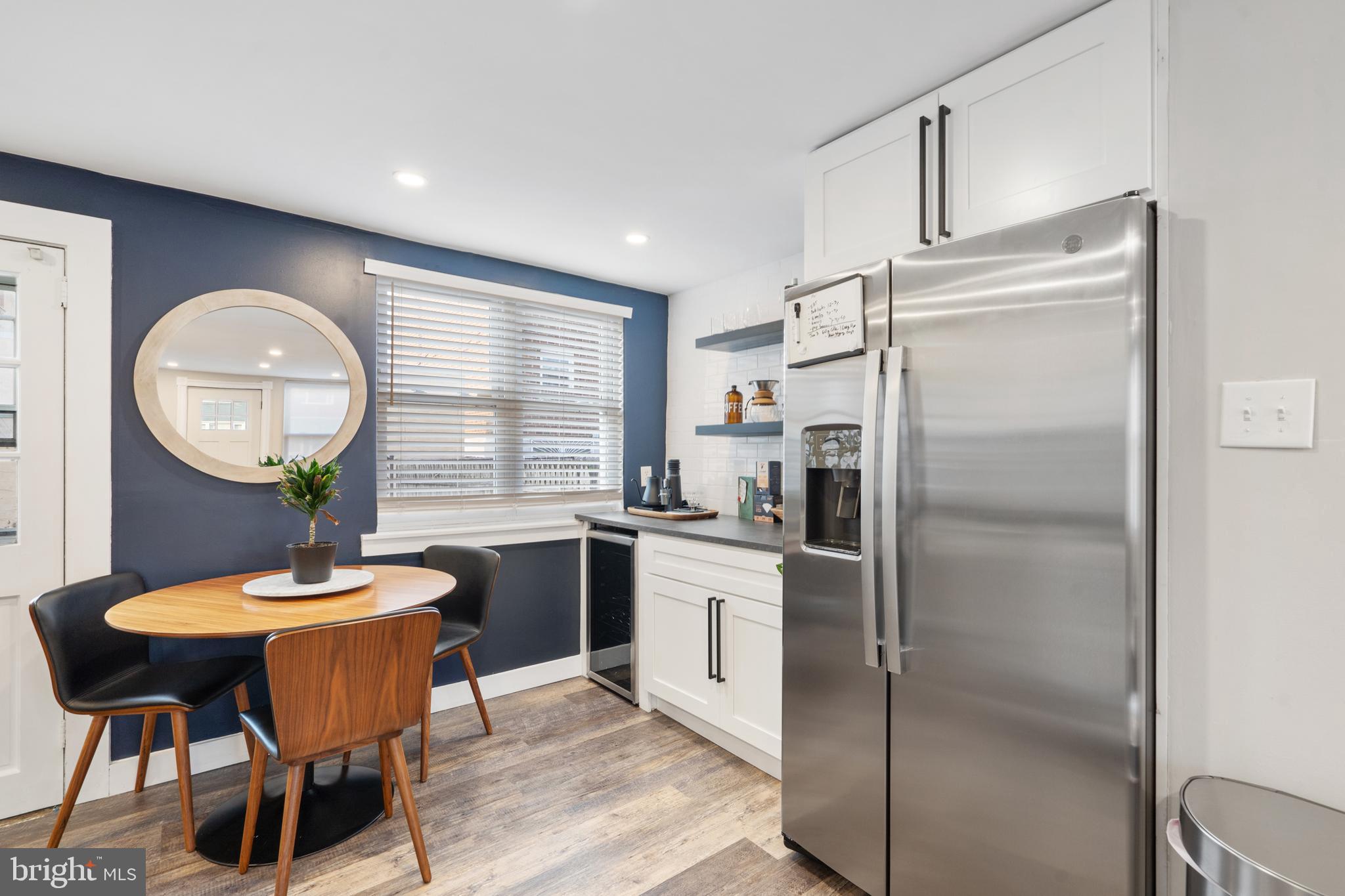 3606 Miller Street Philadelphia, PA 19134 - Photo 11 of 24 a kitchen with stainless steel appliances a refrigerator a table chairs and a refrigerator