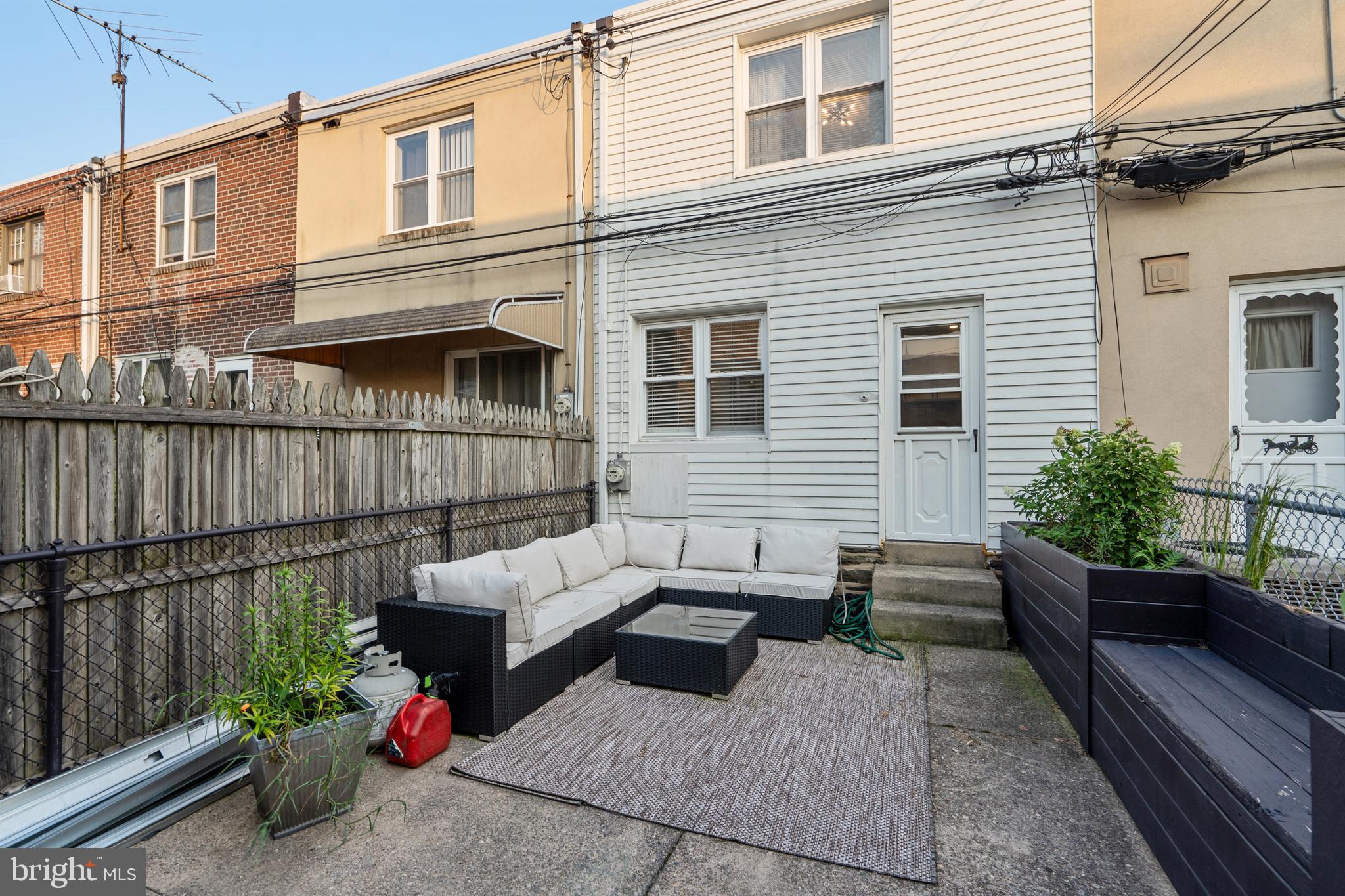 3606 Miller Street Philadelphia, PA 19134 - Photo 21 of 24 a view of a patio with couches chairs potted plants and wooden fence