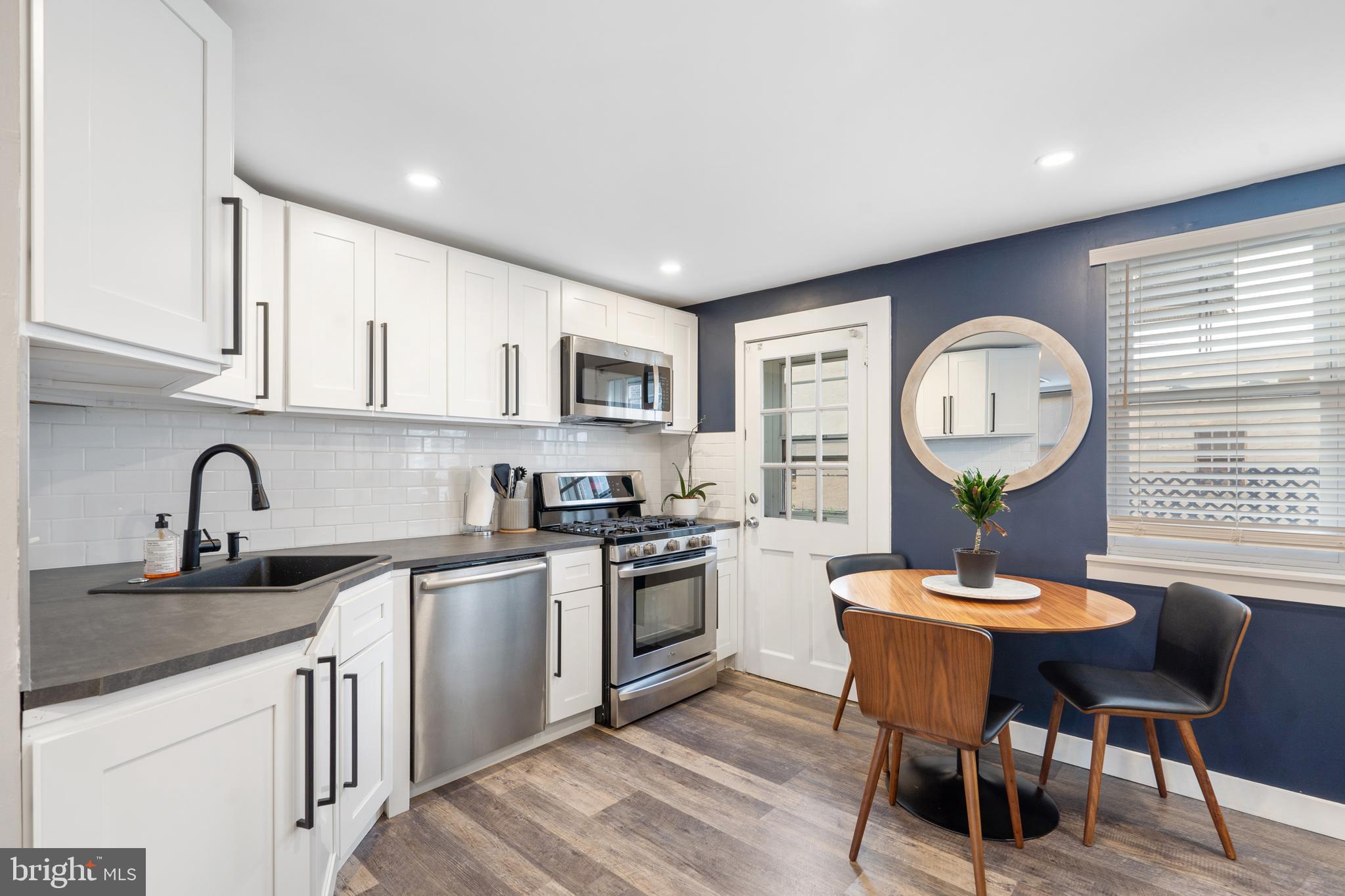 3606 Miller Street Philadelphia, PA 19134 - Photo 9 of 24 a kitchen with a table chairs sink and cabinets