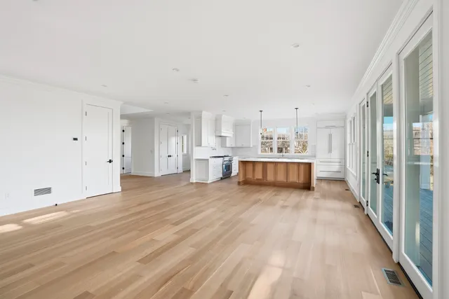 a view of empty room with wooden floor and fireplace