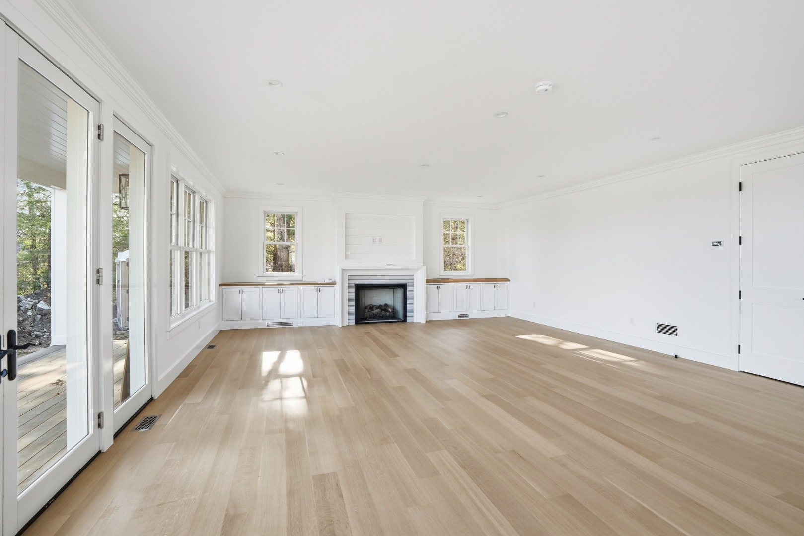 35 Mt Aldworth Road Vineyard Haven, MA 02568 - Photo 4 of 41 a view of empty room with wooden floor and fireplace
