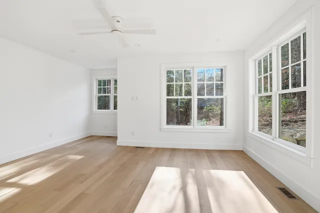 a view of empty room with wooden floor
