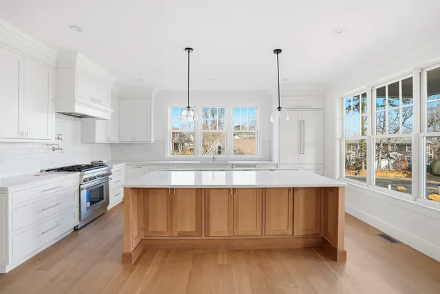 a view of a room with wooden floor and windows