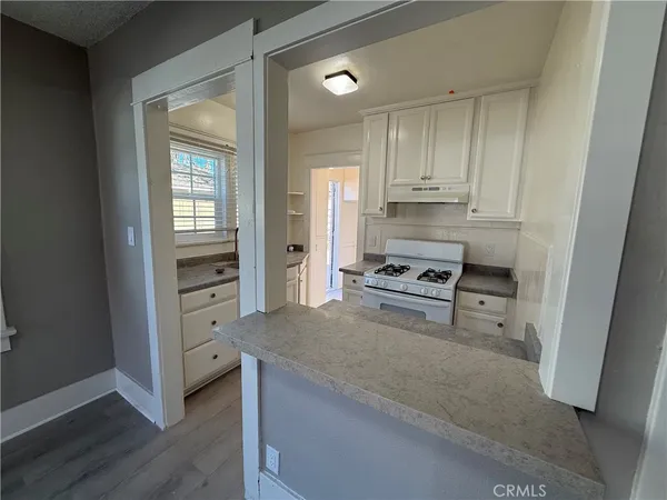 a kitchen with cabinets and a stove