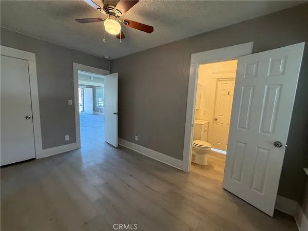 an empty room with wooden floor and door