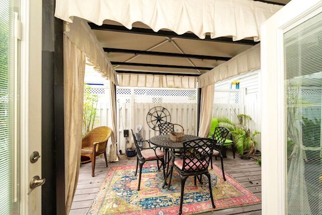 1218 Packer Street, Unit REAR Key West, FL 33040 - Photo 16 of 22 a view of a patio with table and chairs and potted plants