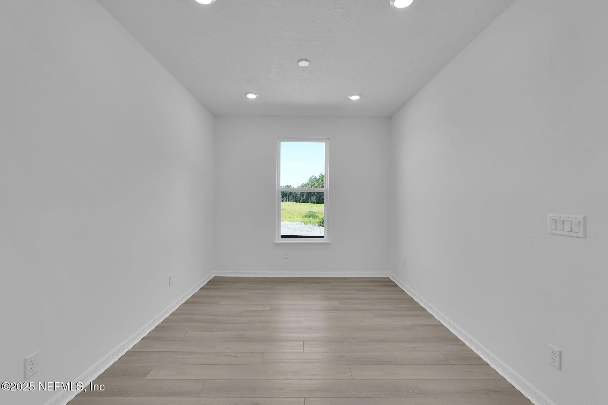 134 Headstream Drive St. Johns, FL 32259 - Photo 20 of 28 a view of an empty room with wooden floor and a window
