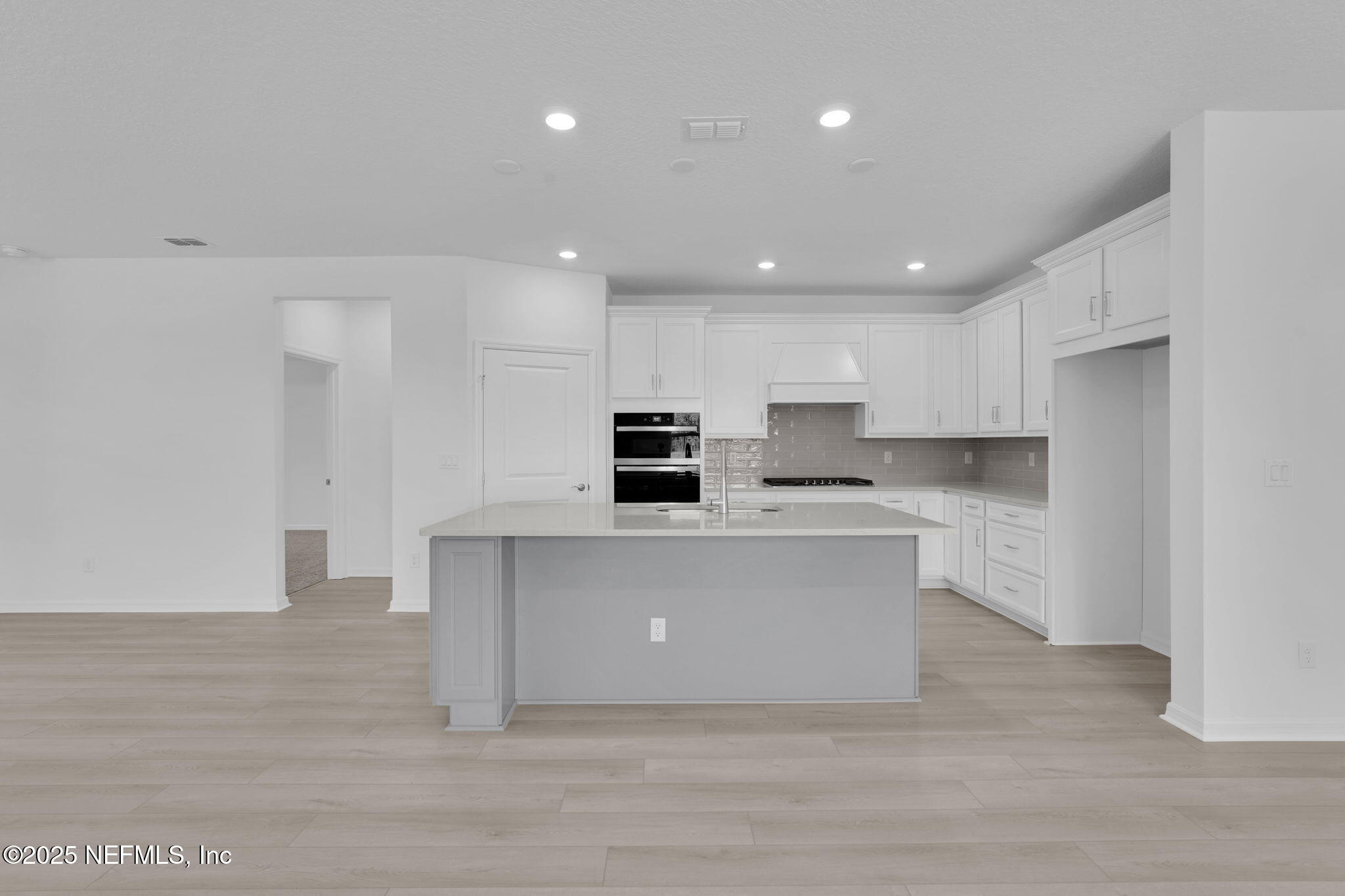 134 Headstream Drive St. Johns, FL 32259 - Photo 7 of 28 a view of kitchen with kitchen island stainless steel appliances a sink and cabinets