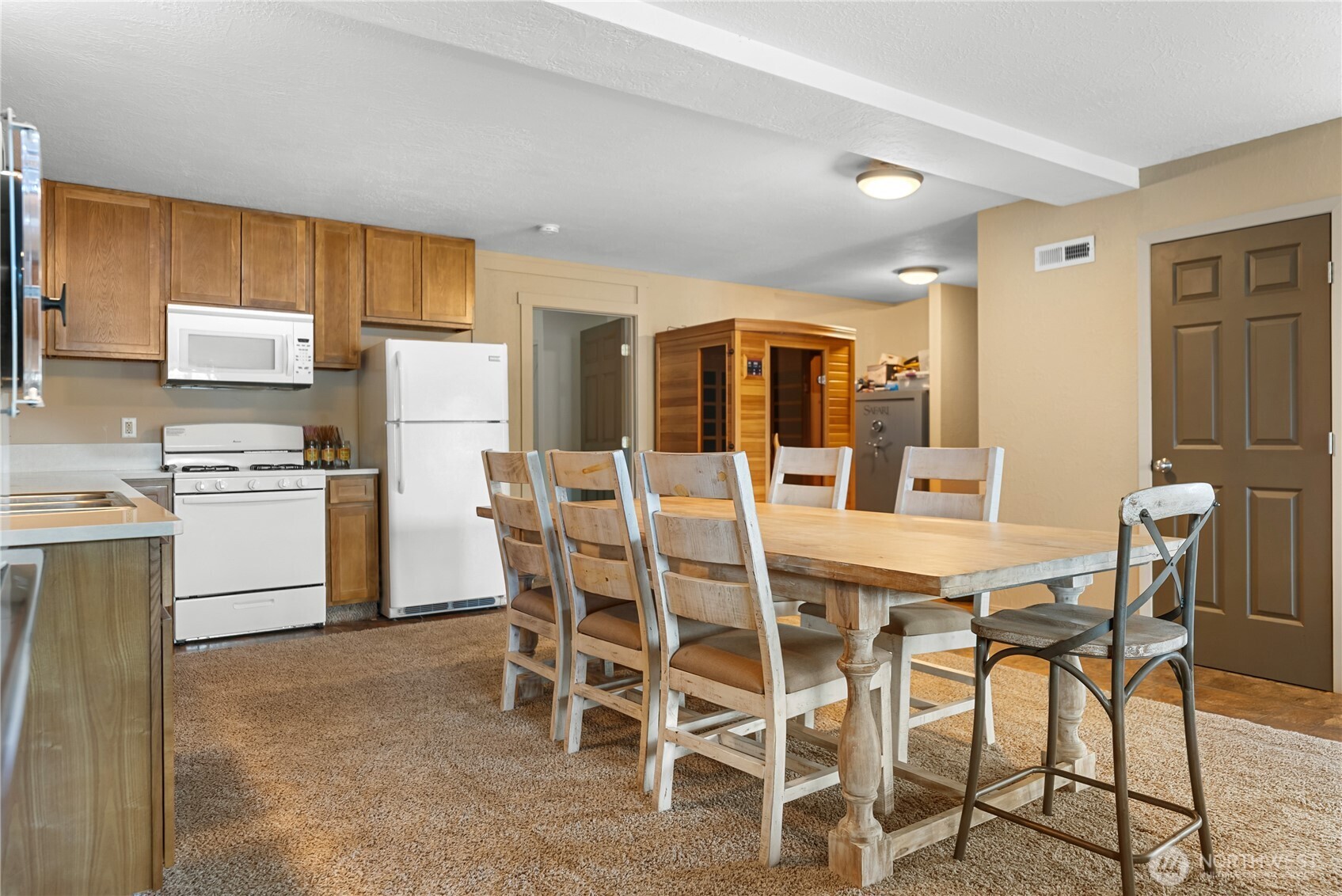 65 Eastlake Road, Unit B Oroville, WA 98844 - Photo 30 of 40 a dining room with furniture a kitchen island and stainless steel appliances