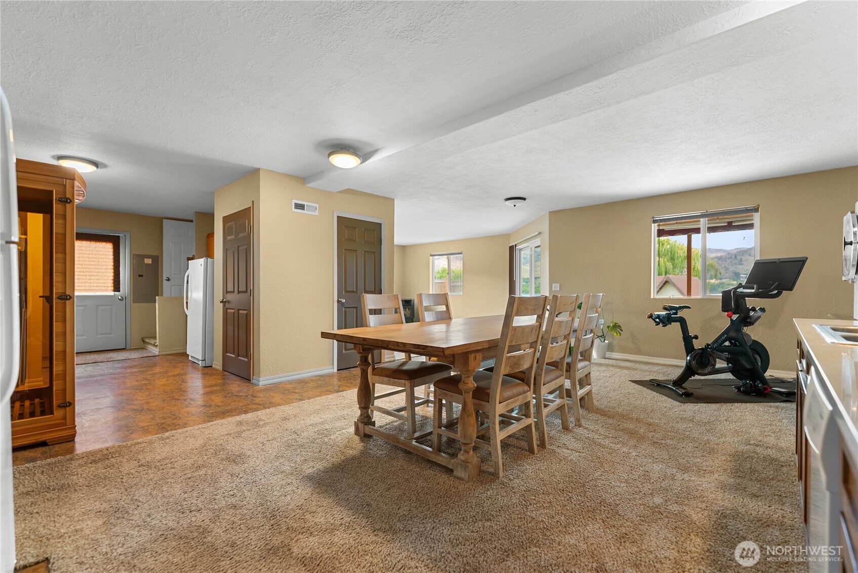 65 Eastlake Road, Unit B Oroville, WA 98844 - Photo 31 of 40 a view of a dining room with furniture and a chandelier