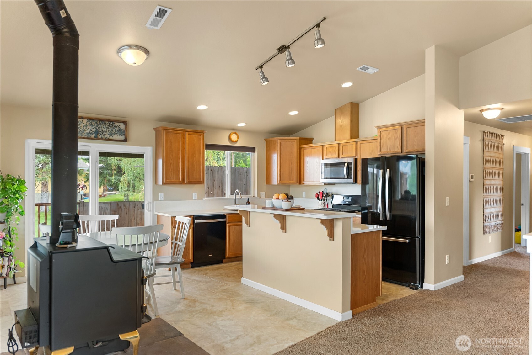 65 Eastlake Road, Unit B Oroville, WA 98844 - Photo 9 of 40 a kitchen with refrigerator and cabinets