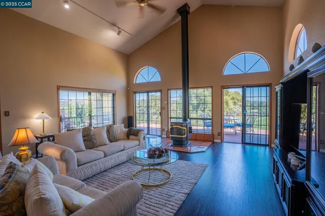 a living room with furniture fireplace and a large window